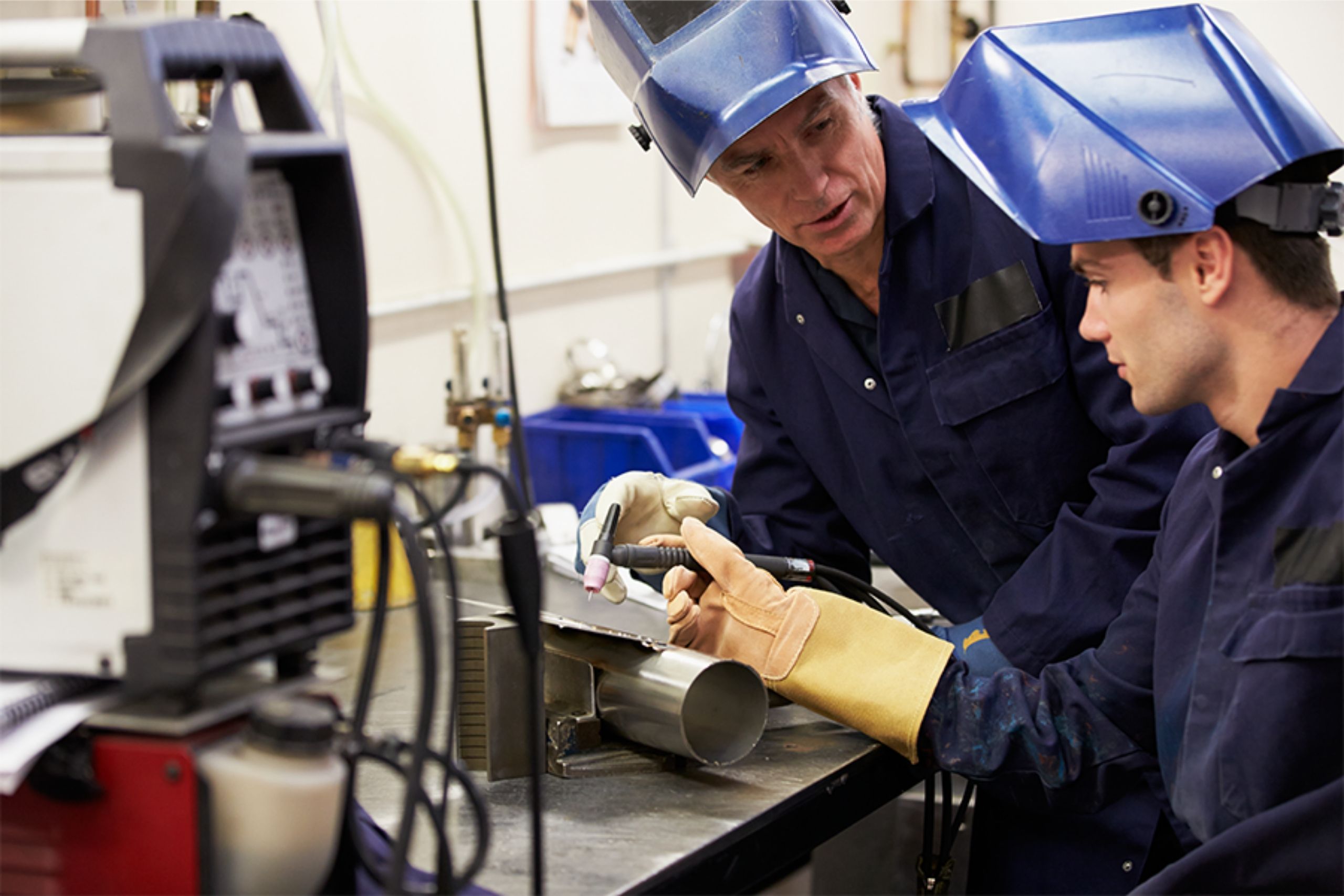 Two skilled labor workers in a manufacturing plant